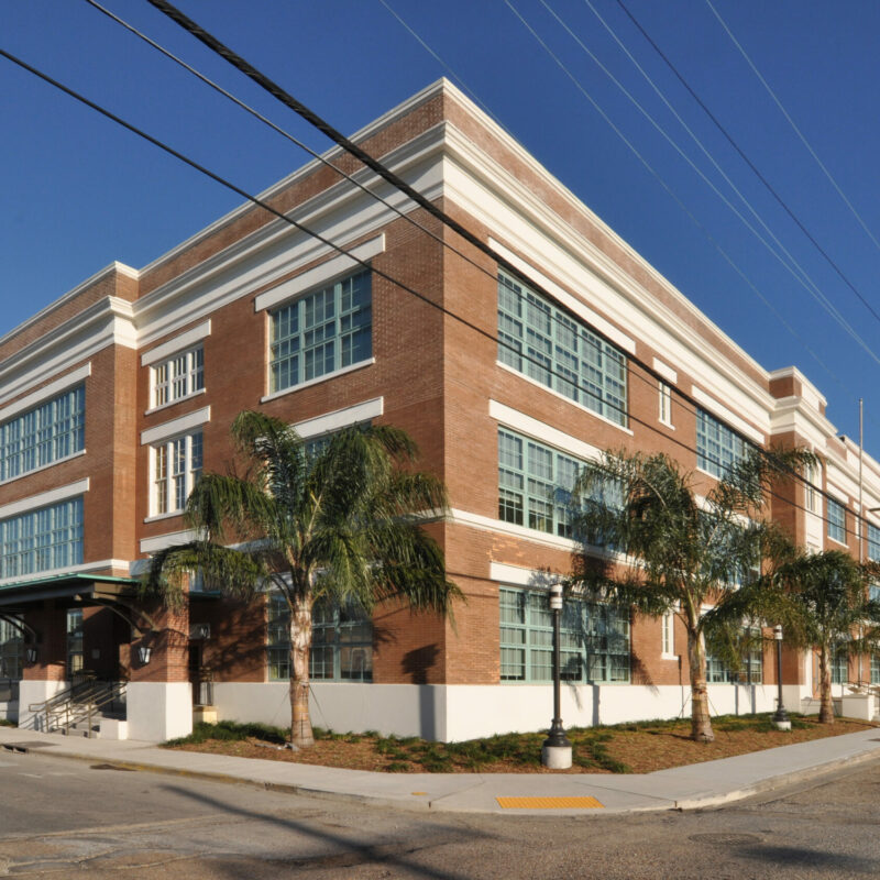 Brick building with palm trees